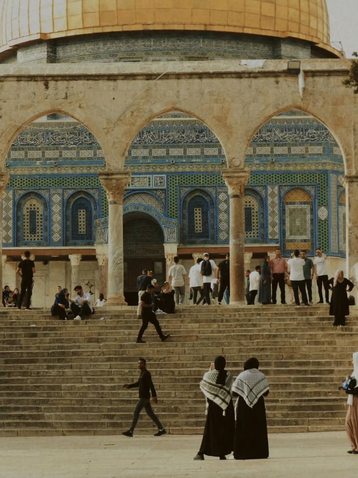 The Dome of the Rock seen through a stone arcade